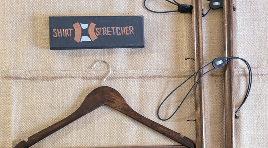 Shirt Stretcher components displayed on a wooden table, featuring a hand-drawn logo of the Shirt Stretcher, emphasizing its handcrafted design and sustainability.